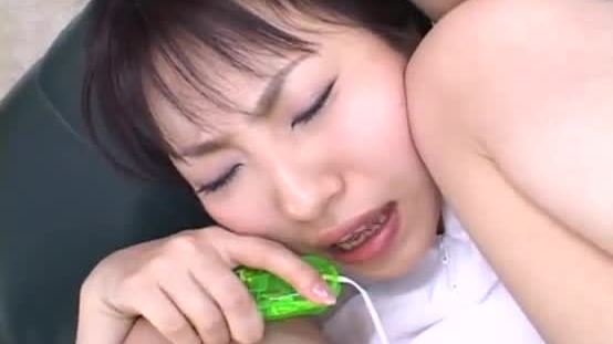 Japanese teen has her trimmed pussy toyed by a green vibrator